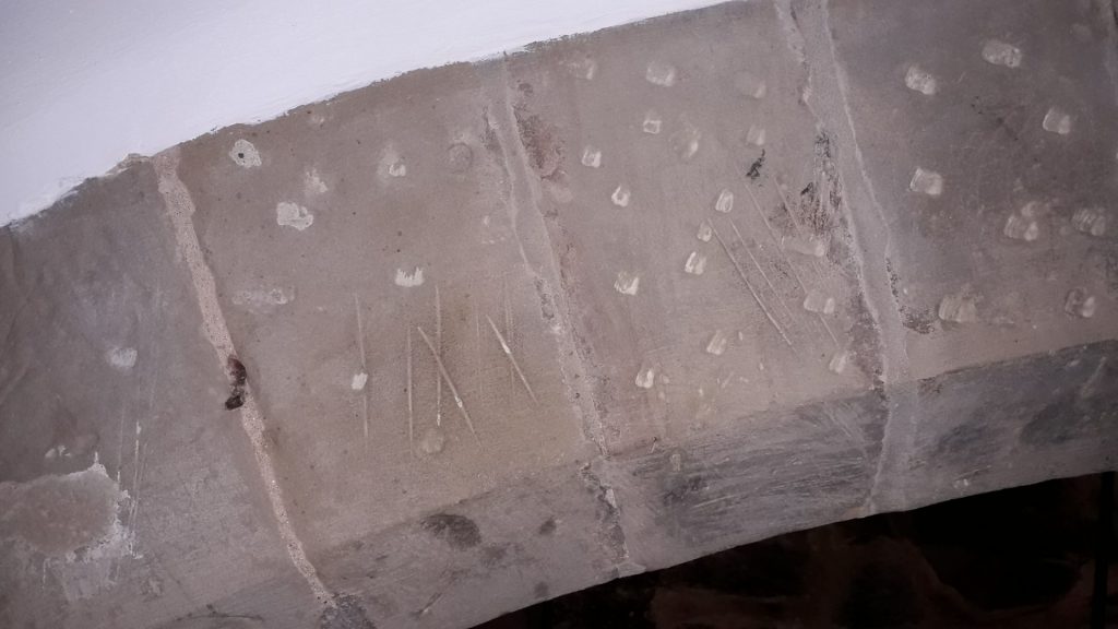 An anti-witch mark carved on the kitchen fireplace