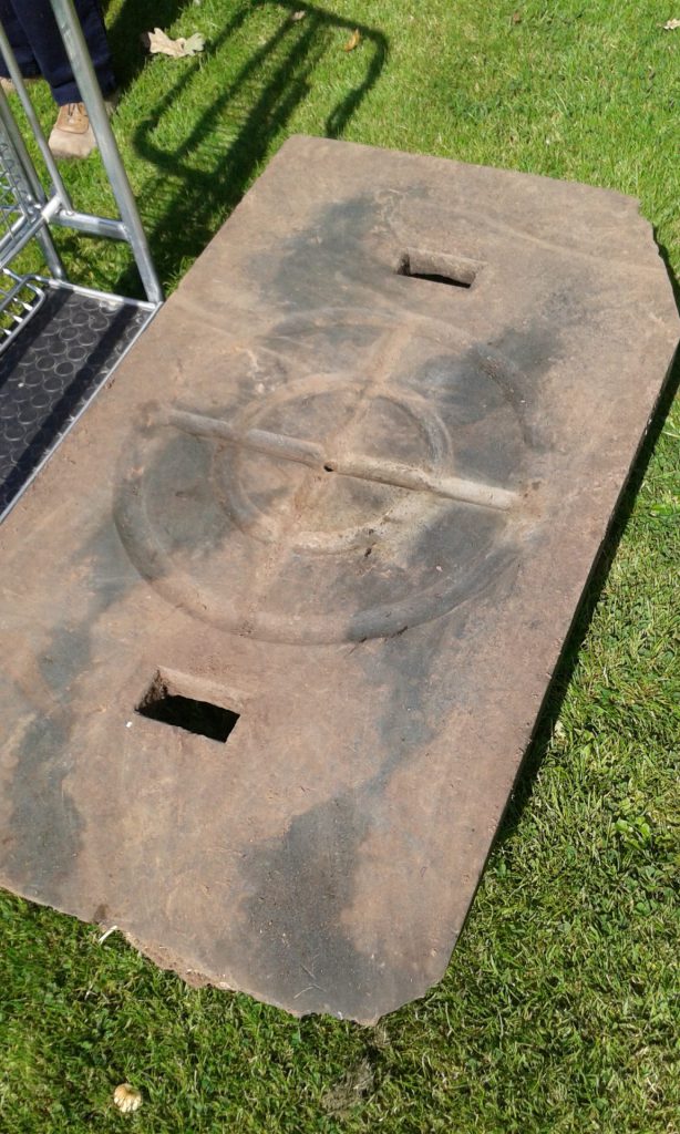An original slate cheese press base from the house after excavation from the garden