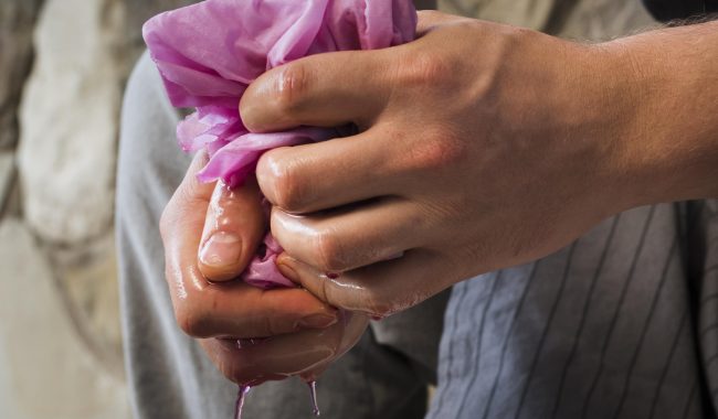 Sideways Man Squeezing Cloth From Natural Pigment Scaled Aspect Ratio 650 380