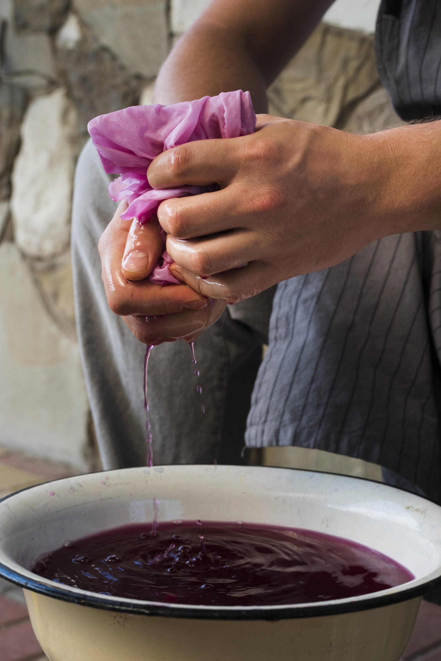 Sideways Man Squeezing Cloth From Natural Pigment Scaled Aspect Ratio 640 340